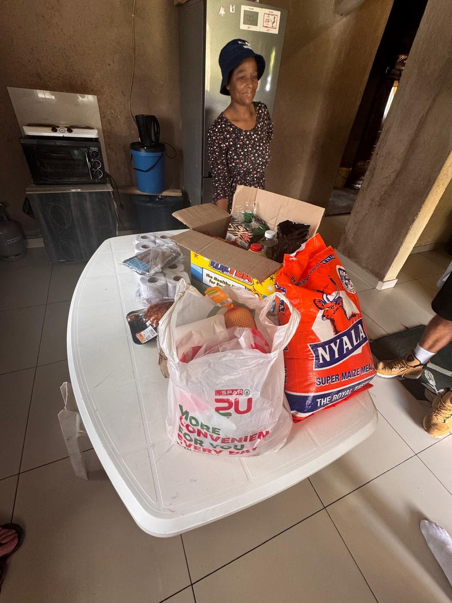 A food parcel, maize meal and groceries delivered to a family