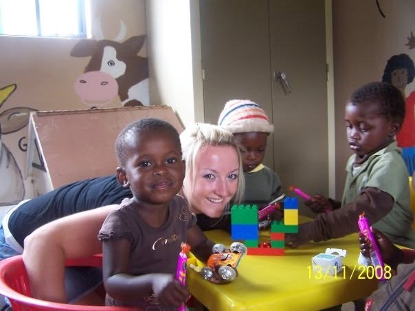 A young Claire playing with children at a community crèche in 2008