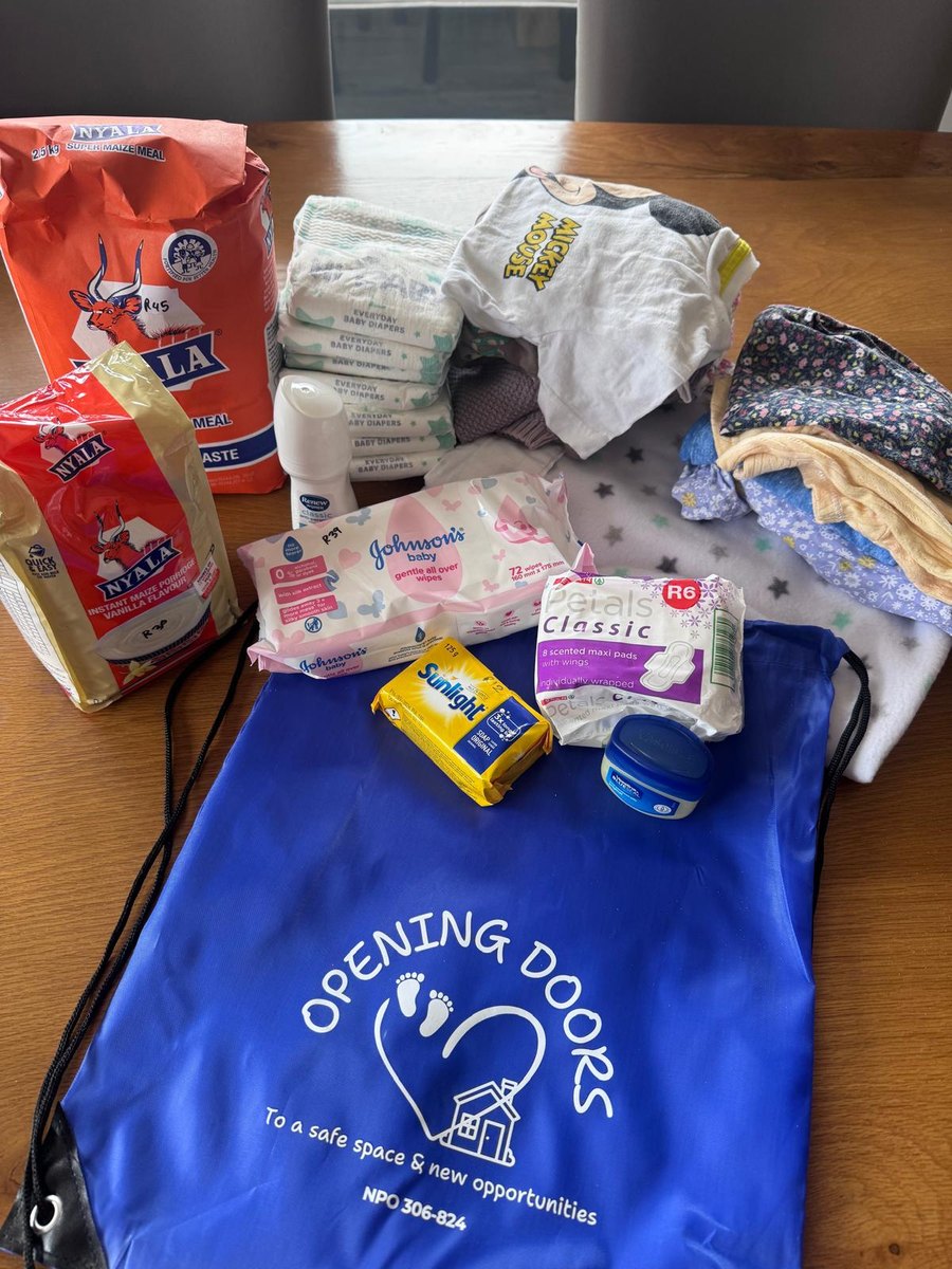 A Young Mum & Baby Bag with its contents: nappies, wipes, soap, vaseline, sanitary towels and a blanket