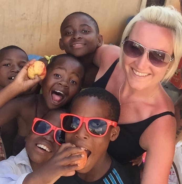 Claire Revell with children from the community