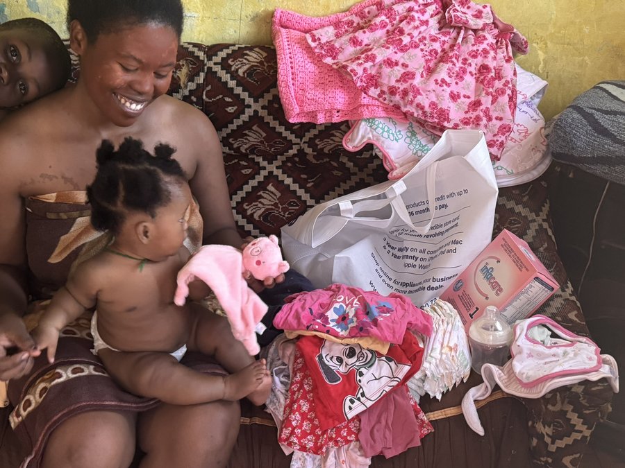 A young mum with her baby and baby essentials